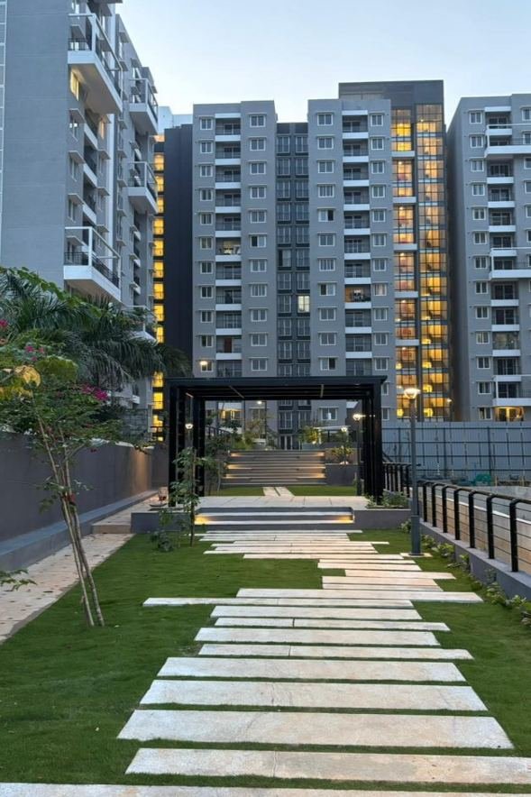 Stone pathway and pergola between residential towers