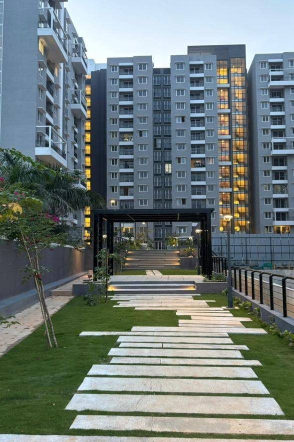 Stone pathway and pergola between residential towers